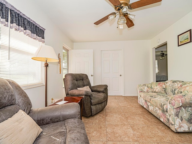 tiled living room with ceiling fan