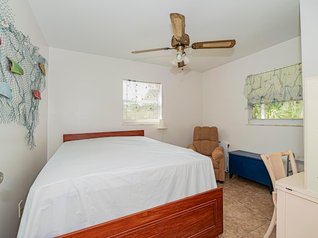 tiled bedroom with ceiling fan