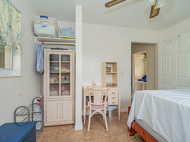 tiled bedroom featuring ceiling fan