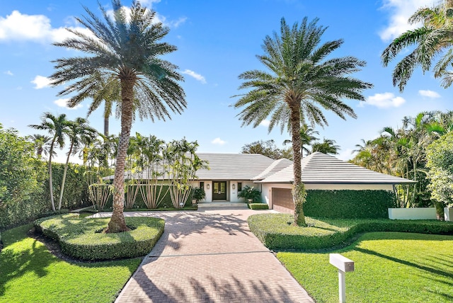 view of front facade with a garage and a front yard