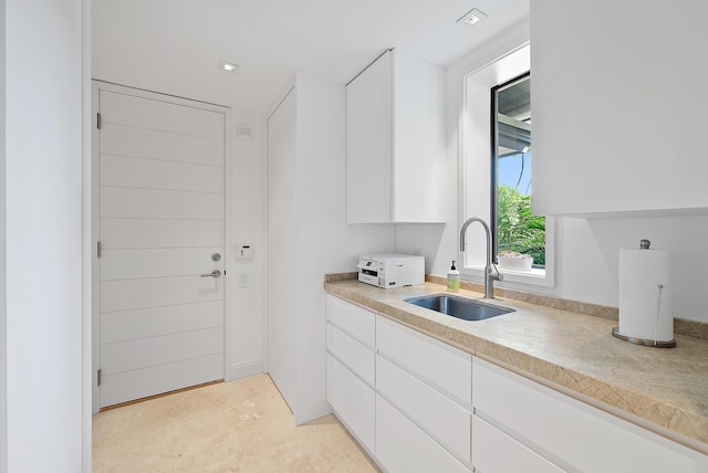 clothes washing area with sink