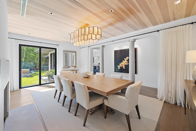 dining space featuring light wood-type flooring and wood ceiling