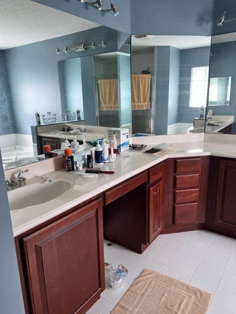 bathroom featuring a shower, a textured ceiling, vanity, and tile patterned floors