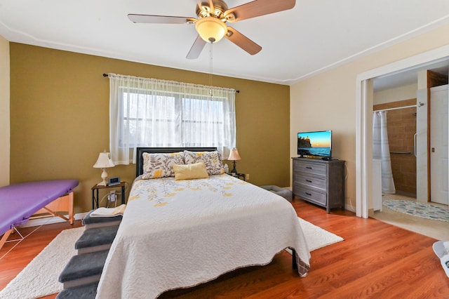 bedroom with hardwood / wood-style floors, ceiling fan, and ensuite bathroom