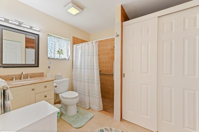 bathroom with toilet, tile patterned flooring, vanity, and walk in shower