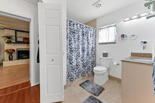 bathroom with tile patterned floors, vanity, and toilet