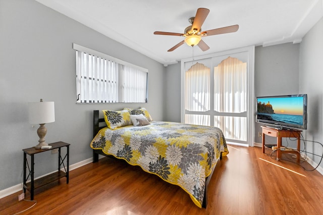 bedroom with hardwood / wood-style floors and ceiling fan