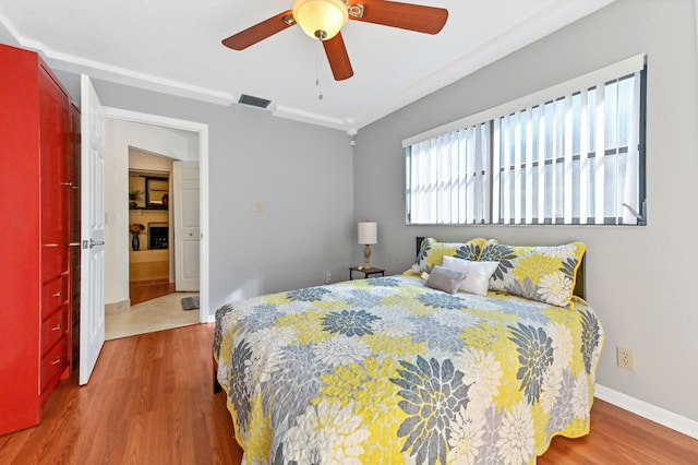 bedroom with wood-type flooring and ceiling fan