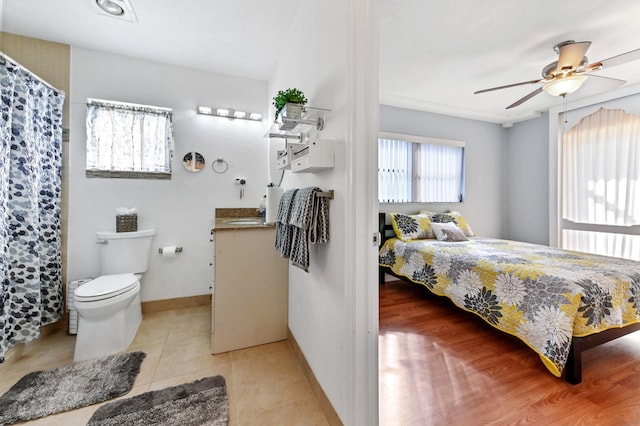 bedroom with sink, ceiling fan, and light tile patterned flooring