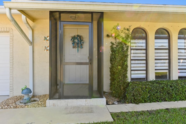 entrance to property featuring stucco siding