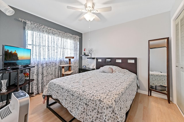 bedroom with a closet, ceiling fan, and light hardwood / wood-style flooring