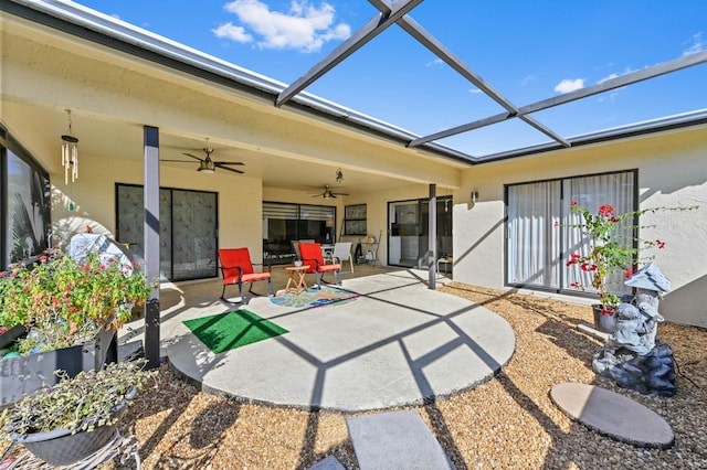 view of patio / terrace with ceiling fan and a lanai