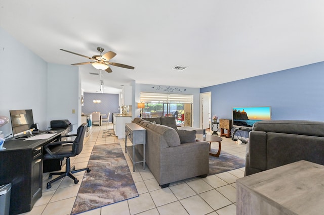 living room with ceiling fan and light tile patterned floors