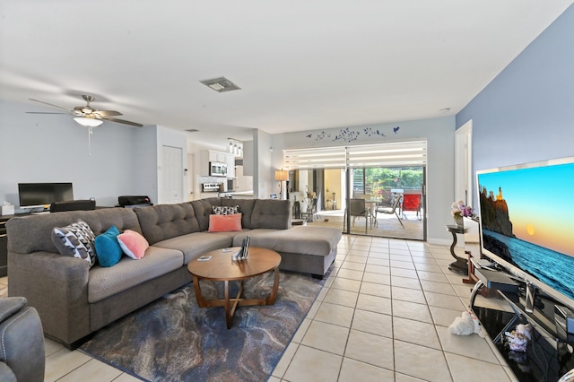 living room with ceiling fan and light tile patterned floors