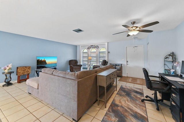 living room with ceiling fan and light tile patterned flooring