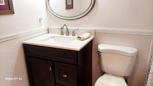 bathroom with toilet and vanity