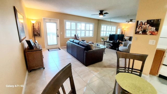 living room featuring ceiling fan and light tile patterned floors