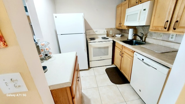 kitchen featuring backsplash, light tile patterned floors, light brown cabinetry, sink, and white appliances