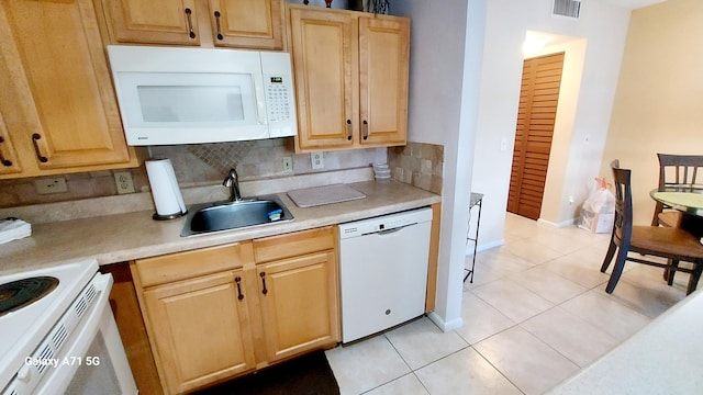 kitchen featuring tasteful backsplash, light tile patterned floors, light brown cabinetry, sink, and white appliances