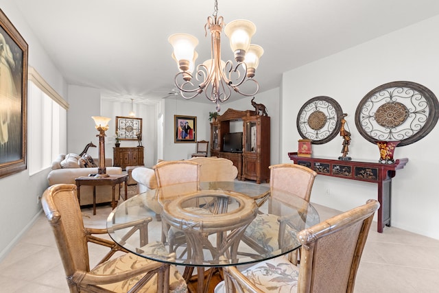 dining area featuring a notable chandelier and light tile patterned floors