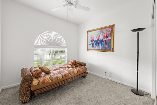 living area featuring carpet and ceiling fan