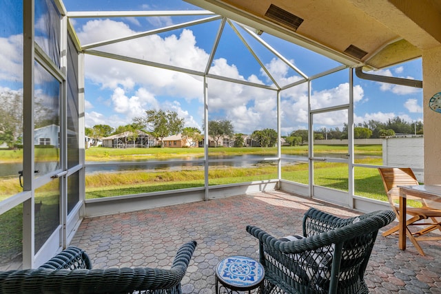 sunroom / solarium with a water view