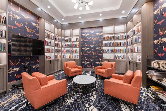 living area featuring a tray ceiling and built in features