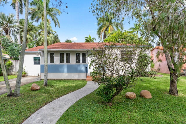 ranch-style house with a front lawn