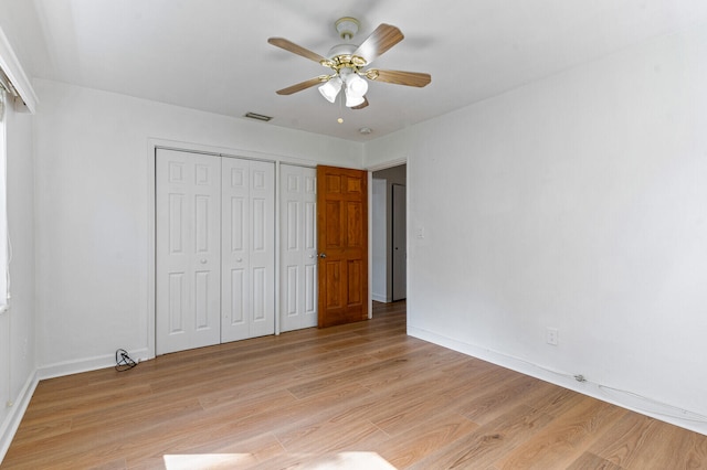 unfurnished bedroom with a closet, ceiling fan, and light hardwood / wood-style flooring