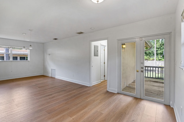 empty room featuring light hardwood / wood-style flooring and french doors