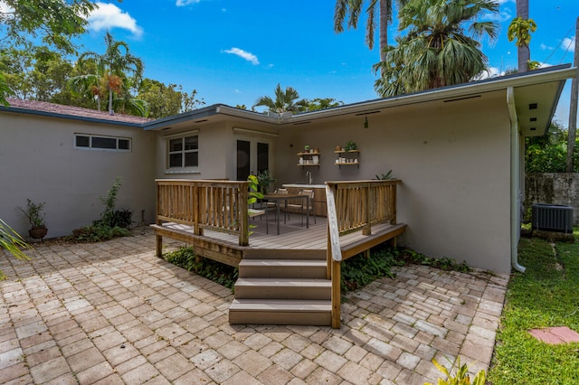 rear view of house featuring a deck and cooling unit