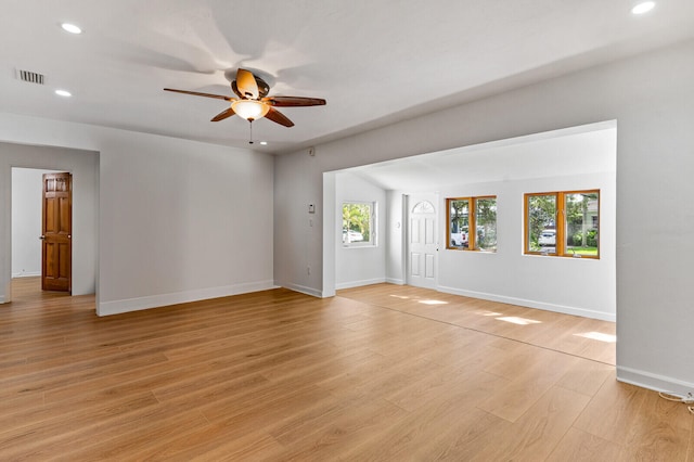 unfurnished living room with ceiling fan, light hardwood / wood-style floors, and plenty of natural light