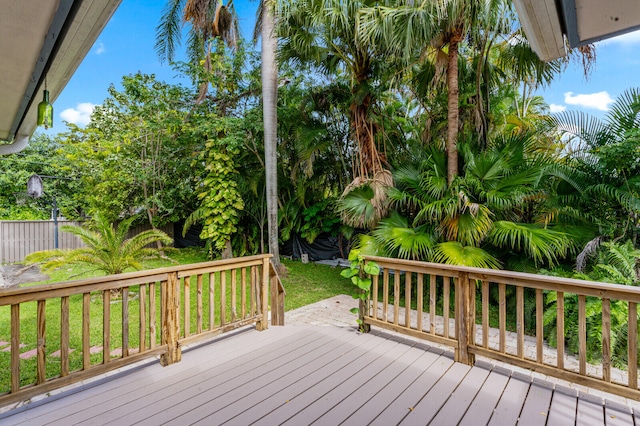 wooden terrace featuring a lawn