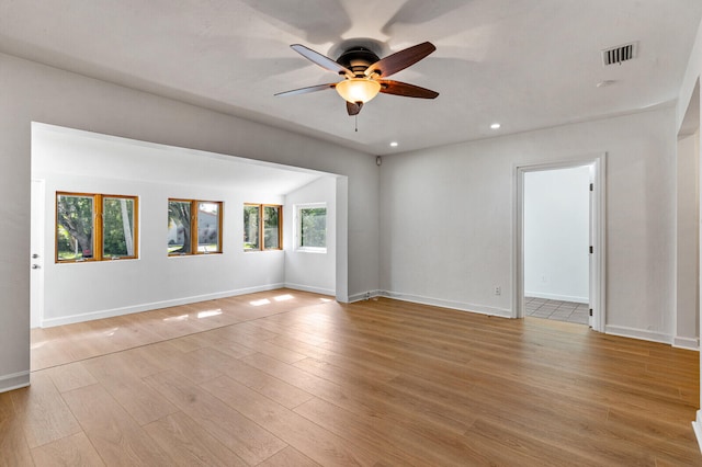 empty room featuring light hardwood / wood-style floors, ceiling fan, and a healthy amount of sunlight