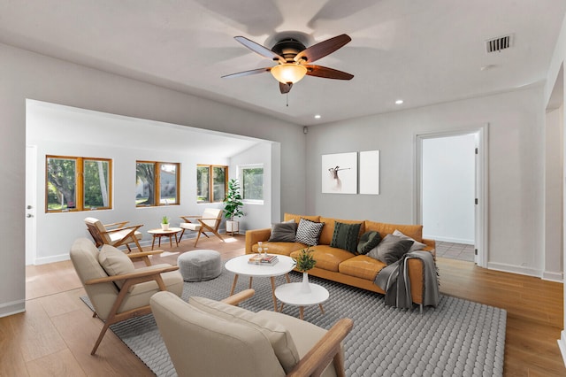 living room featuring ceiling fan and light hardwood / wood-style flooring