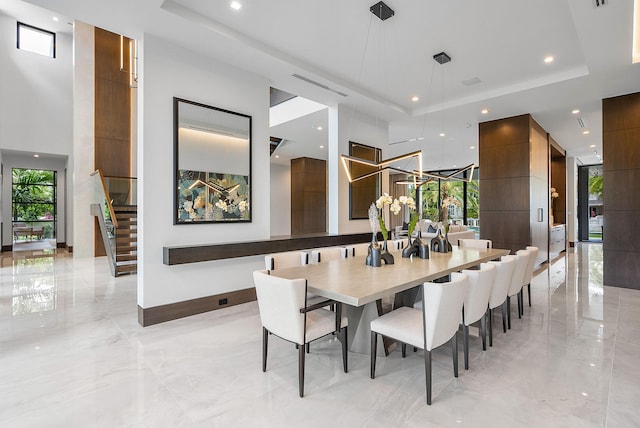 dining room with a raised ceiling