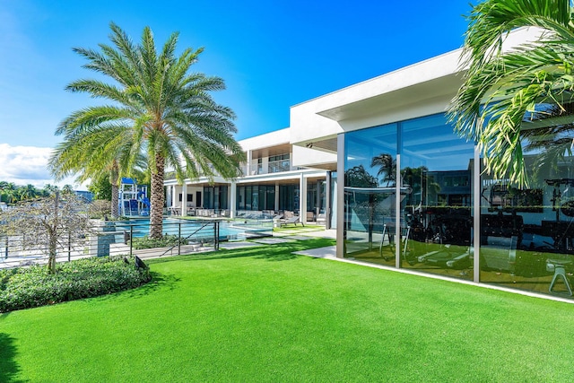 298 W Key Palm Rd, Boca Raton, FL 33432 - view of grassy yard featuring an outdoor pool and a balcony