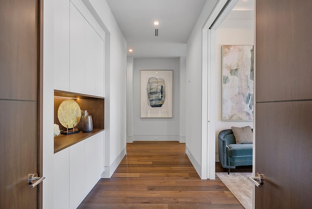 corridor with dark hardwood / wood-style floors