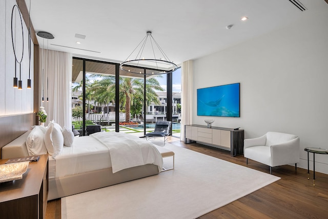 bedroom featuring floor to ceiling windows, access to exterior, dark wood-type flooring, and multiple windows