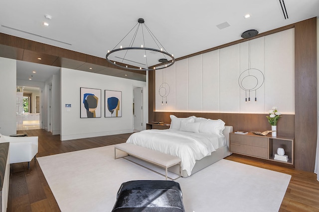 bedroom featuring hardwood / wood-style flooring and an inviting chandelier