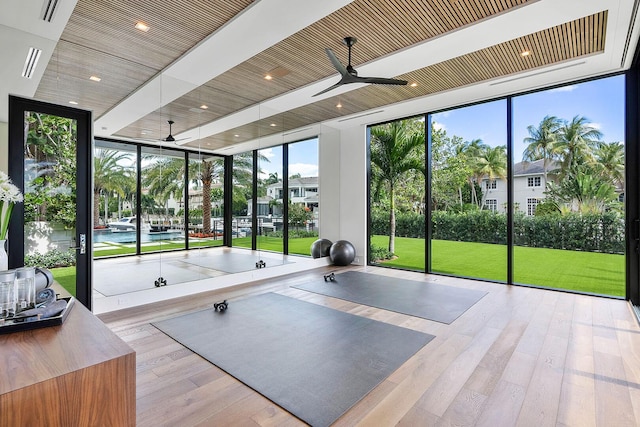298 W Key Palm Rd, Boca Raton, FL 33432 - exercise area with a wall of windows, a ceiling fan, and wood-type flooring