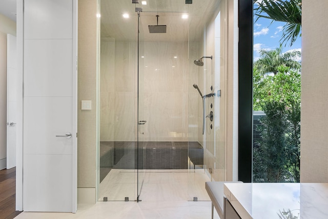 bathroom with hardwood / wood-style floors and walk in shower