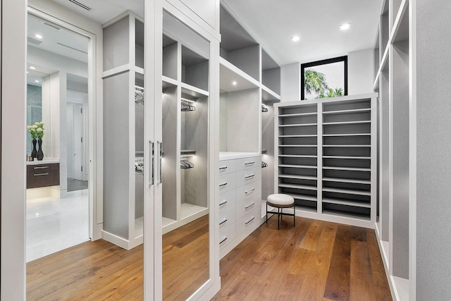 walk in closet with hardwood / wood-style floors