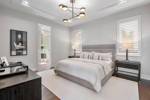 298 W Key Palm Rd, Boca Raton, FL 33432 - bedroom featuring wood finished floors, a raised ceiling, a chandelier, and connected bathroom