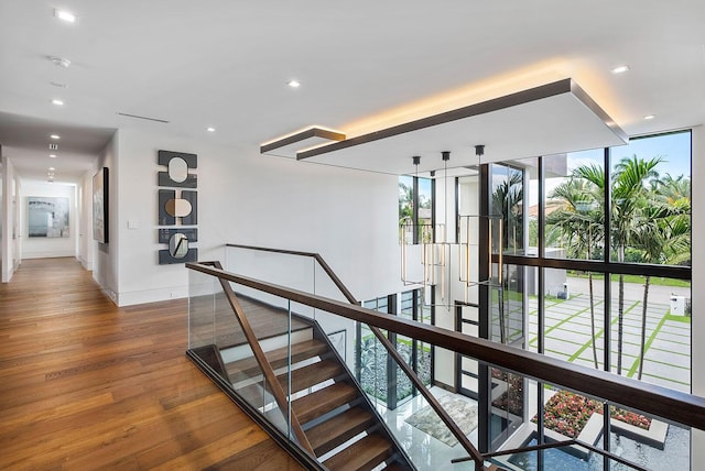 298 W Key Palm Rd, Boca Raton, FL 33432 - hallway featuring wood finished floors, an upstairs landing, recessed lighting, baseboards, and expansive windows