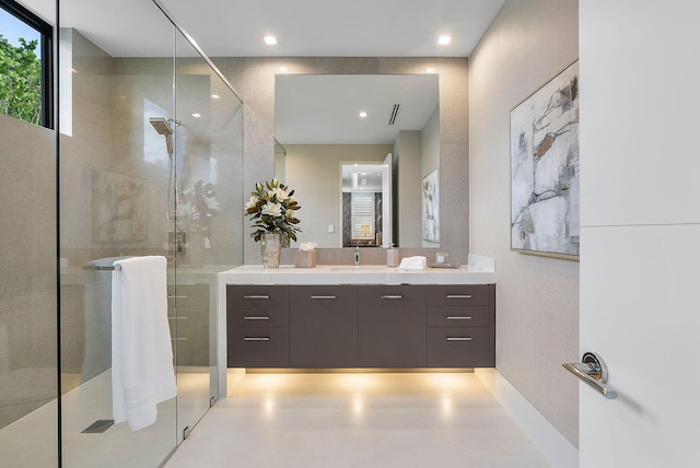 bathroom featuring vanity and a shower with door