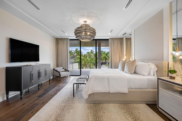 bedroom with a chandelier, access to outside, dark hardwood / wood-style floors, and floor to ceiling windows