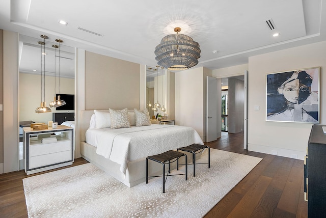 bedroom with a notable chandelier and dark hardwood / wood-style flooring