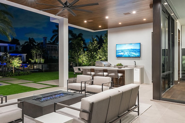 view of patio / terrace with an outdoor kitchen, an outdoor living space with a fire pit, ceiling fan, sink, and a grill