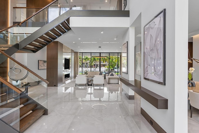 298 W Key Palm Rd, Boca Raton, FL 33432 - building lobby featuring stairway, a towering ceiling, and floor to ceiling windows